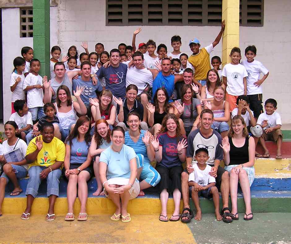team from UK on steps of classrooms at CBC