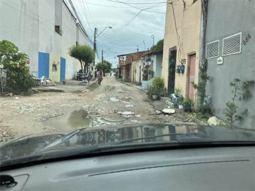 Street view from a car window in the favalas on a Sunday morning