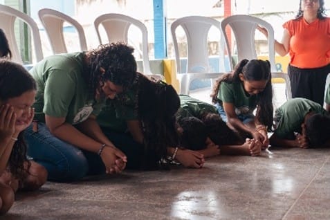 Children kneeling in prayer